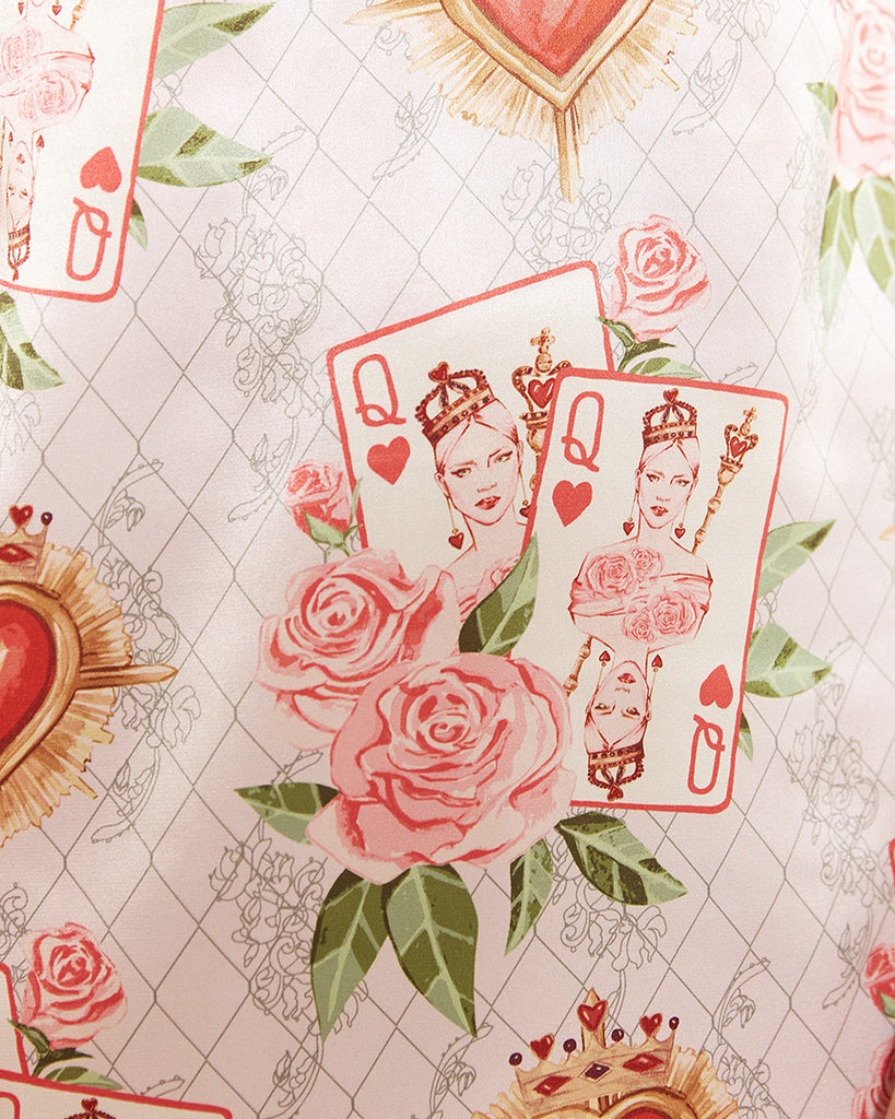 Bella Descanso Queen of Hearts Valentine's Day limited edition print. Featuring pink roses, playing cards and red hearts. The perfect Valentine's Day gift for her. A beautiful stin slip dress adaptable from sleep to street style. Comfortable for lounging and can also be dressed up as a satin cocktail dress, or party dress. Luxury loungewear, resort wear, satin dress, silk dress. 